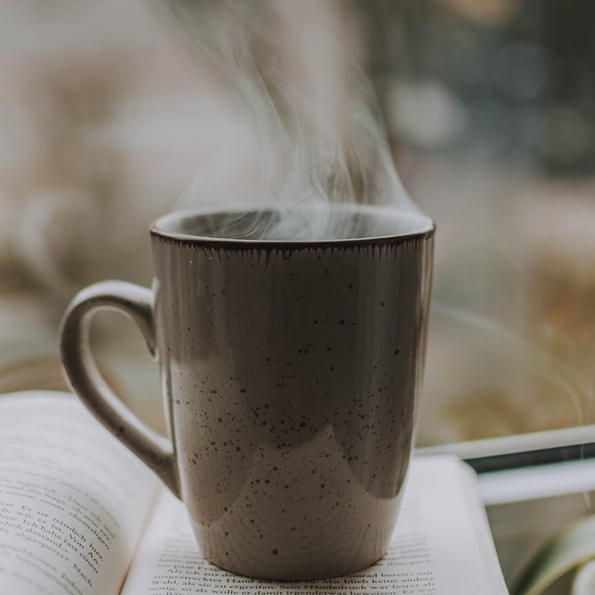 photo of coffee mug on top of book