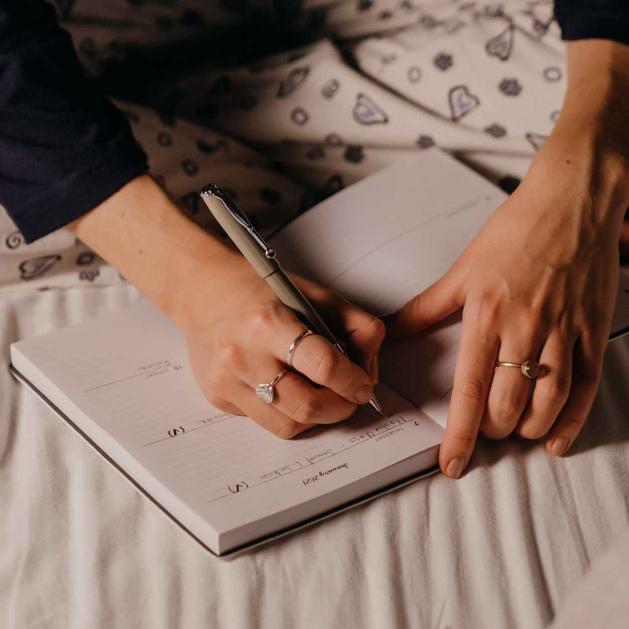 a person writing on a journal